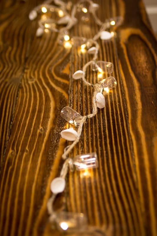 Christmas lights on a burnt wood coffee table
