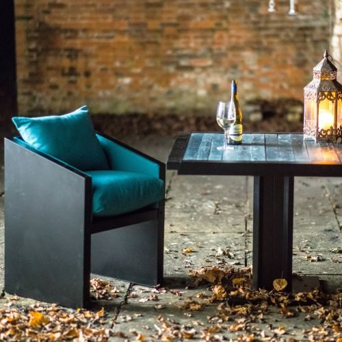 Industrial style bistro table with turquoise top and complimentary cushions
