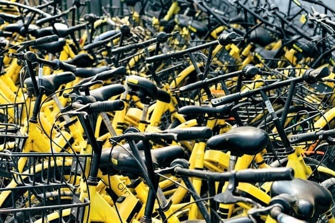a crowd of yellow bicycles